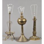 * Table Lamps. A Victorian brass table lamp, with strap work decoration on a hexagonal base, 38.