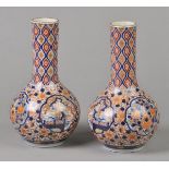 * Japanese Vase. A pair of Japanese porcelain bulbous vases, decorated with four vignettes of