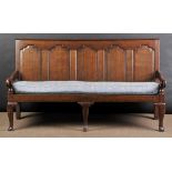 * Settle. A good early 19th century oak settle, the straight back with five carved panels, carved