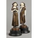 * Art Nouveau . A pair of Continental bronze chryselephatine figures, circa 1900, modelled as a girl