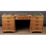 * Partners Desk. An early 20th century mahogany desk, the inverted breakfront top with tooled