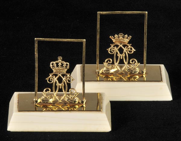 * CITES Menu Holders. A fine pair of George V 18ct menu holders, with interlaced monogram surmounted