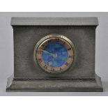 * Liberty. An Edwardian Tudric pewter clock, the rectangular case with beaten finish and moulding,