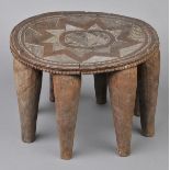 * Tribal Art. A Nupe Tribe, Nigeria carved wooden stool, the oval top geometrically carved on