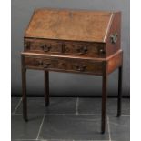 * Bureau. A George III mahogany bureau and stand, c. 1760, the hinged fall opening to reveal