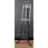 * Artist's Easel. An Aesthetic Movement ebonised easel with foliate carved decoration, spindles