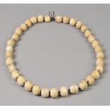 * Chinese Beads. A group of thirty-five Chinese carved bone beads, decorated with seated figures and