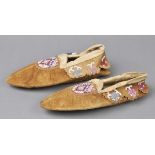 * Moccasins. A pair of North American leather moccasins each worked with coloured beads, 28.5cm