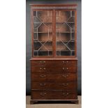 * Secretaire. A George III mahogany secretaire bookcase, the ogee frieze above two astragal glazed