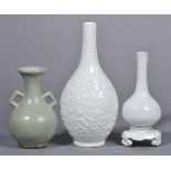* Chinese Vases. A Chinese porcelain blanc de chine bottle vase with moulded and incised floral