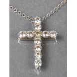 * Tiffany & Co. A modern platinum and diamond cross pendant, set with eleven small diamonds, stamped