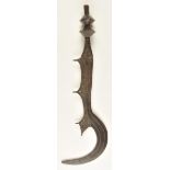 *Ngulu. A Congo sword, the 49cm blade engraved and with crescent hook, carved wooden grip, 70cm