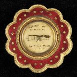 *Doncaster Aviation Meeting 1909. An enamelled gilt metal badge with a vignette of a biplane and