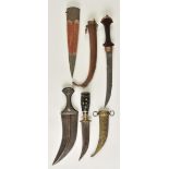 *Jambiya. A 19th-century Arab dagger, the 21cm curved steel blade with horn grip inset with pin