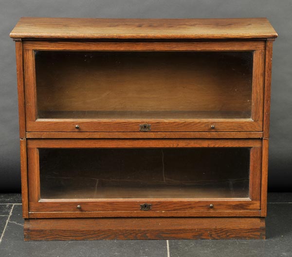 * Bookcase. A 1920s Globe Wernicke-style oak bookcase, with two tiers, glass door each with brass