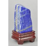 * Lapis lazuli. A good coloured boulder with banding, 13.5cm high, presented on a wooden stand (1)
