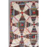 * American Quilt. A log cabin patchwork quilt, circa 1940s, hand-stitched pineapple pattern cotton