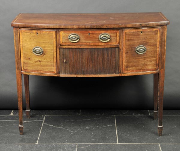 * Sideboard. A George III mahogany bowfront sideboard, with rosewood Trafalgar crossbanding above