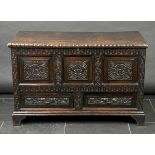 * Chest. A 19th-century carved oak chest, the rectangular top enclosing candle box, the front panel