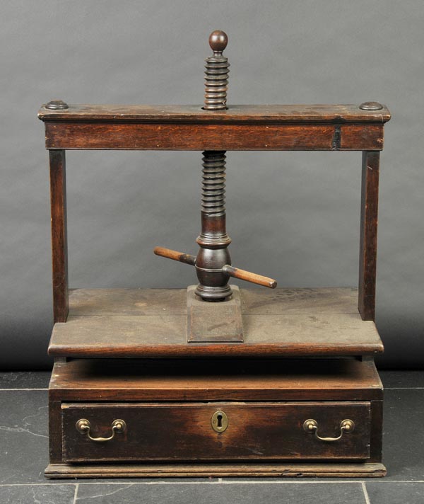 * Linen press. An early 19th-century mahogany table top linen press, with large turning bar on