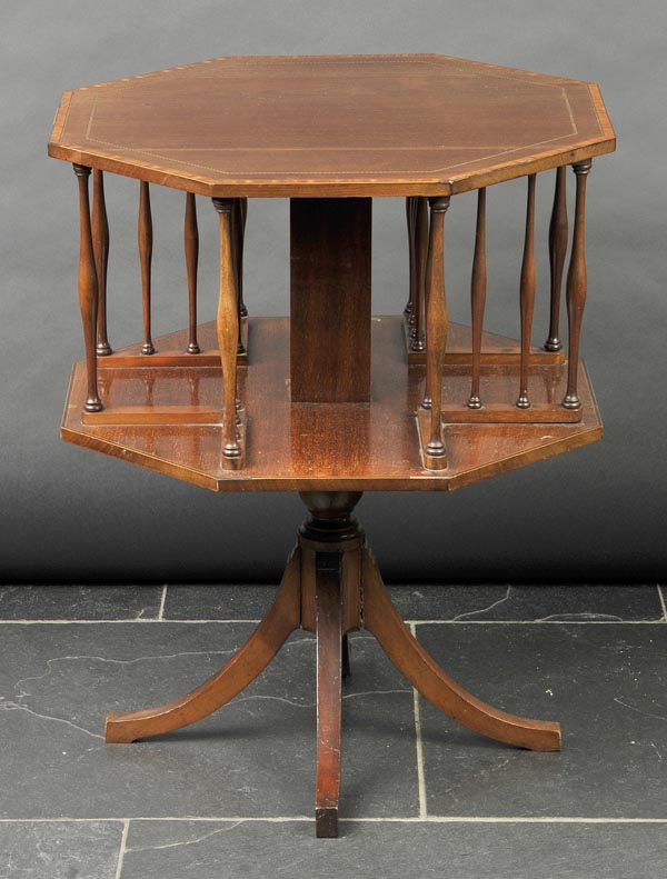 * Book table. An Edwardian mahogany revolving book table, the octagonal top inlaid with barber’s
