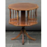 * Book table. An Edwardian mahogany revolving book table, the octagonal top inlaid with barber’s