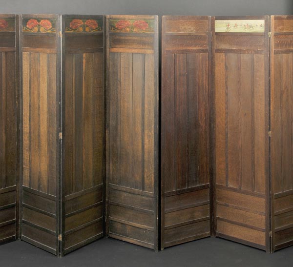 * Arts and Crafts. An oak four-fold screen with pokerwork floral decoration in red, orange and