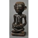 * West Africa. A Yoruba Tribe carved wood maternity figure, carved holding child with scarification