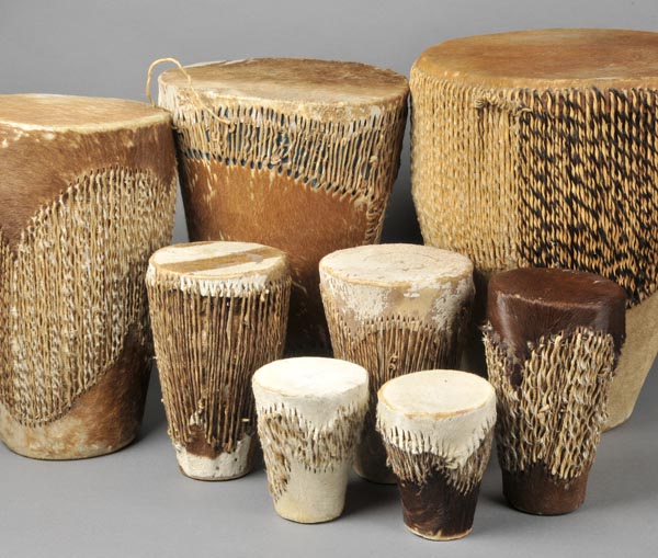 * Drums. A collection of eight African animal hide drums, various sizes, largest 48cm high x 38cm