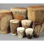 * Drums. A collection of eight African animal hide drums, various sizes, largest 48cm high x 38cm