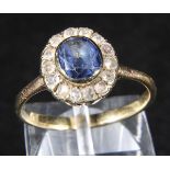 *Ring. A yellow metal cluster ring, set with central sapphire and surmounted by pave set