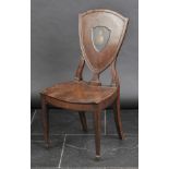 *Chair. A George III mahogany hall chair,  the shield back painted with crest, solid seat on tapered