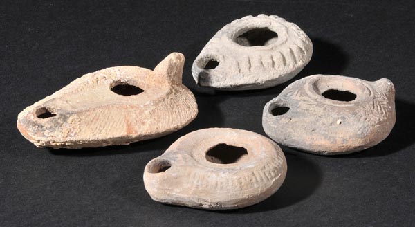 *Roman Pottery. A collection of four Roman teracotta lamps, various dates, 2nd to 4th century,