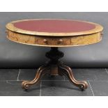 *Table. A Victorian walnut drum table,  the circular top inset with Morrocan leatherette, four