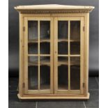 *Cabinet. A Victorian pine hanging corner cabinet,  with dentil moulding, two glazed doors,