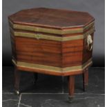 *Cellerette. A George III mahogany cellerette,  of octagonal form bound in brass with lion's head