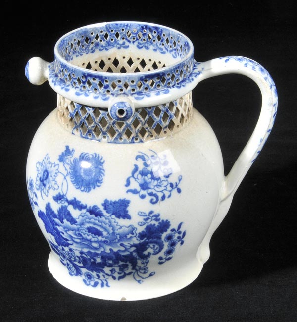 *Puzzle Jug. A 19th century blue and white pottery jug,  probably Welsh, of baluster form with