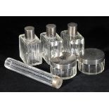 *Dressing table bottles. A collection of Art Deco silver top bottles and jars, belonging to the