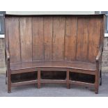 *Settle. An antique oak settle, probably early 19th century,  of curved form with panel back,