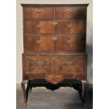 *Chest. A George III walnut chest on stand,  the top with two short and three long drawers, the base