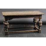 *Table. A Charles I-period oak refectory table,  the rectangular top above carved frieze on