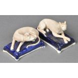 *Staffordshire. A pair of 19th-century pottery recumbent greyhounds, circa 1840,  one modelled