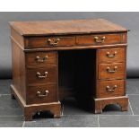 *Desk. A Victorian mahogany kneehole desk,  the rectangular top with inlaid corners, rosewood