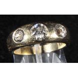 *Ring. An 18ct yellow gold ring set with three pave set graduated diamonds,  inner circumference