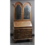 *Bureau Bookcase. An 18th-century walnut bureau bookcase,  the twin arched top with two mirrored