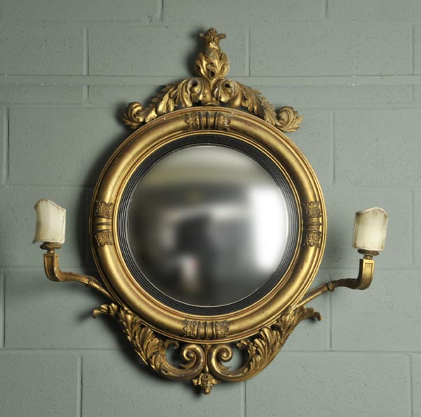 *Mirror. A Regency style convex mirror,  the gilt painted gesso frame with foliate pediment, and