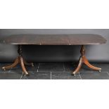 *Dining Table. An Edwardian mahogany twin pillar dining table, in the Regency style,  with d-ends,