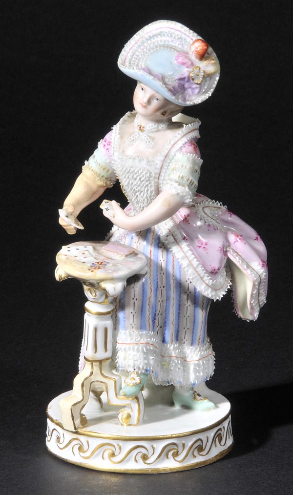 *Meissen. A 19th-century porcelain figure,  modelled as a lady card player with suits of card in