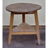 *Table. An early 19th-century elm Cricket table,  the circular top over three supports united by