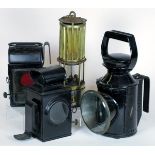 *Four oil-powered lamps. A Premier Lamp and Engineering Co. miner's safety lamp,  having a